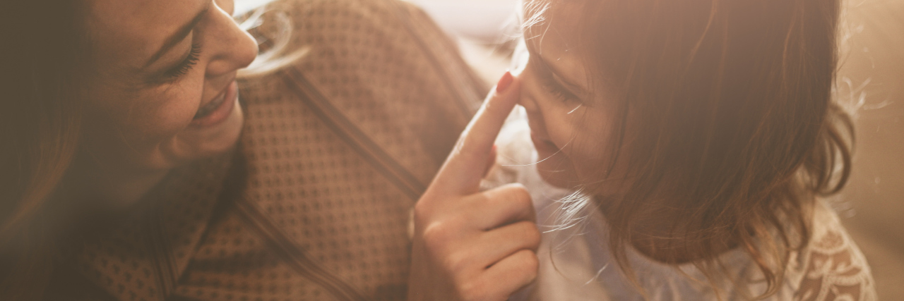 Why I Won't Say I 'Believe' in a Cure for My Child Mother touching daughter's nose.