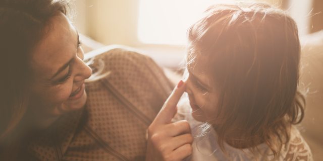 Why I Won't Say I 'Believe' in a Cure for My Child Mother touching daughter's nose.