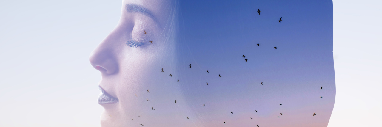 double exposure of a woman with her eyes closed and a sunset with birds flying around