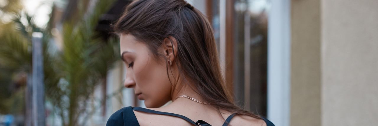 When Others Have a Blinkered Attitude Towards a Shared Illness A photo of a woman looking to her side, in thought.