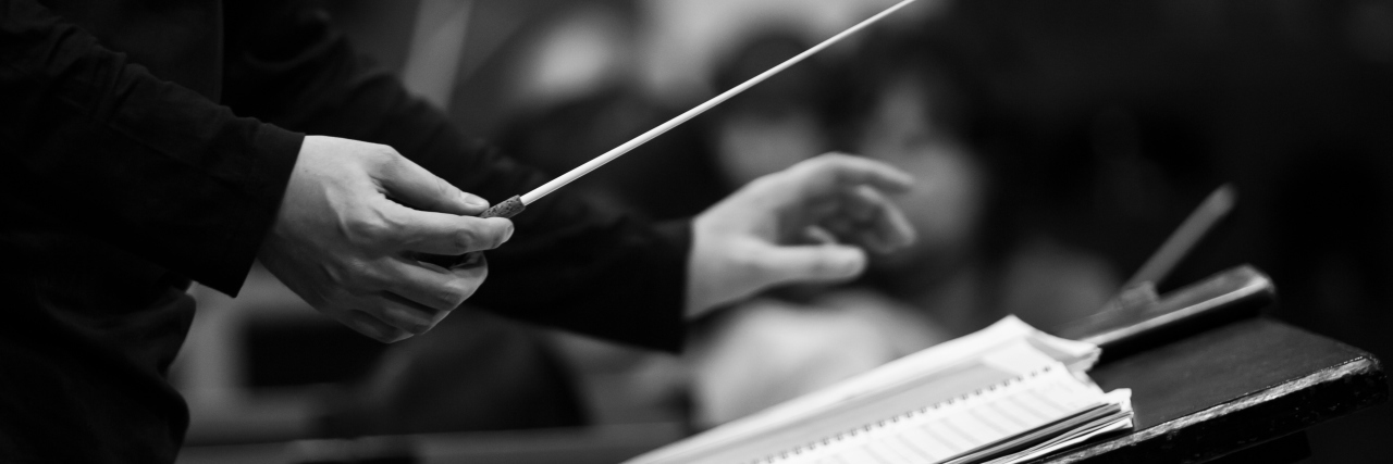 How Listening to Classical Music Helps Me With Chronic Illness black and white photo of a conductor