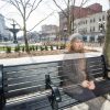 blurred image of a woman sitting on a bench outside in a city