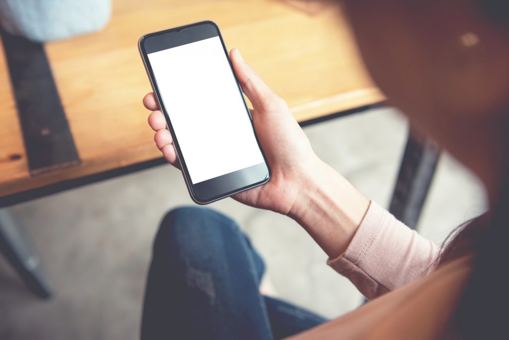 woman looking at her iphone