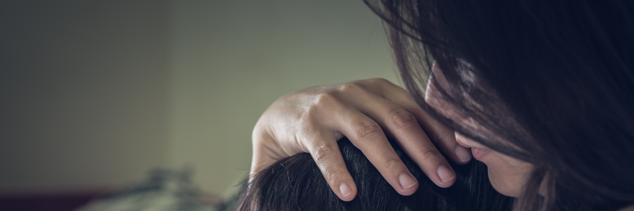 Experiencing Fear When Parenting Your Child With a Rare Disease Closeup sad little boy being hugged by his mother at home.