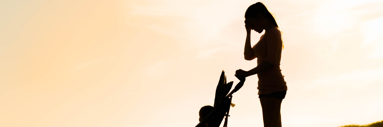 What It's Like to Be a Parent With Relapsing Polychondritis a mother pushing a baby stroller through the field, with her hand on her head, stressed