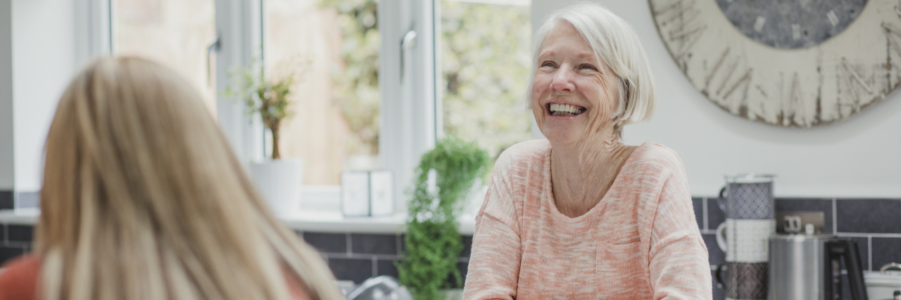 What I Know (and Don't Know) as My Mother's Caregiver An older woman in the kitchen with a smile, and a younger woman standing near her.