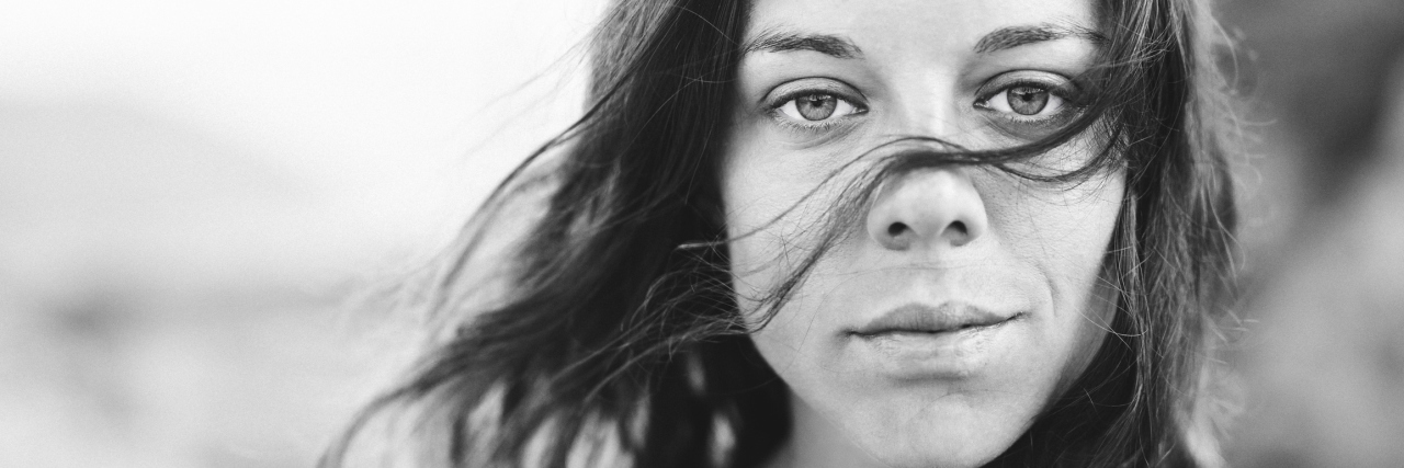 Breaking the Migraine Cycle black and white photo of a woman with long hair