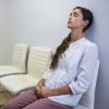 woman sitting in a waiting room with her eyes closed