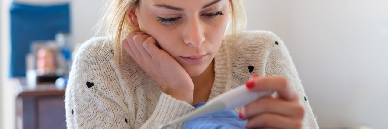 What to Consider When Trying to Conceive After an Eating Disorder Sad young girl reading a pregnancy test result
