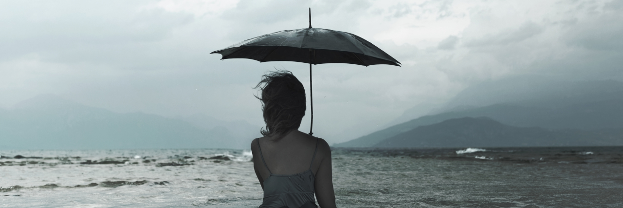 What I Want to Tell Myself as Someone With Depression dreaming woman with umbrella waiting for the storm into the sea