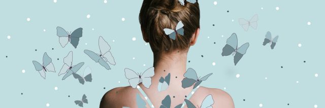 back view of a woman with her hair in a bun against a blue background with butterflies flying around