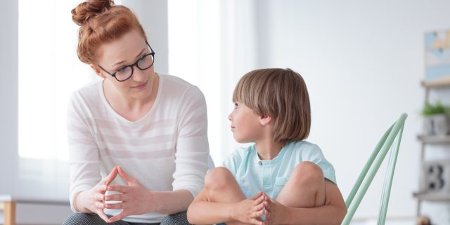 A mom talking to her young son.