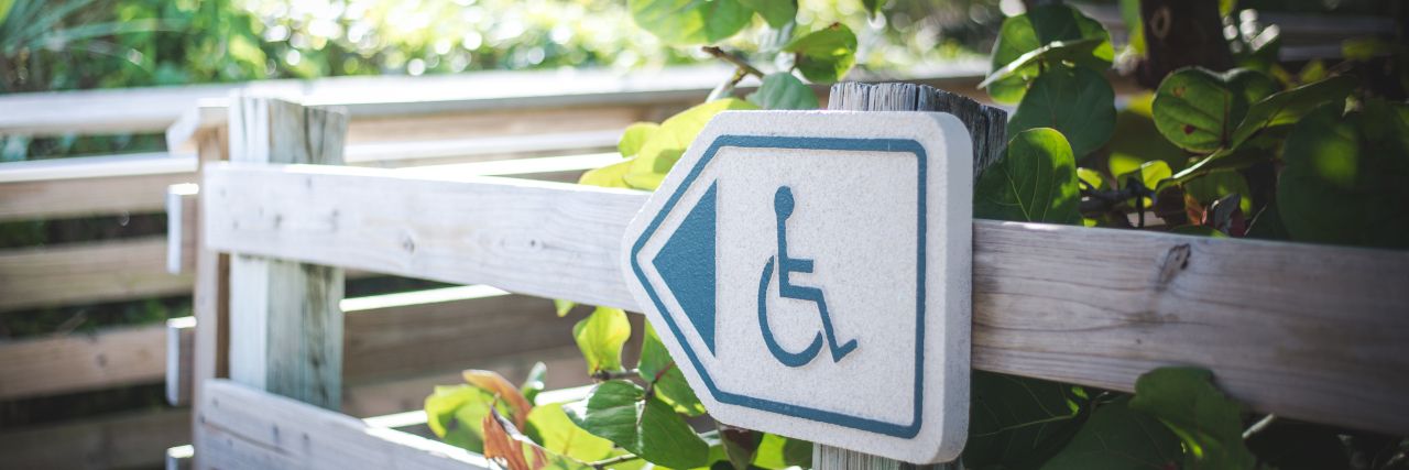 Wheelchair sign on path.