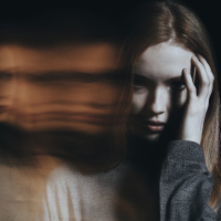 blurred photo of a woman looking worried