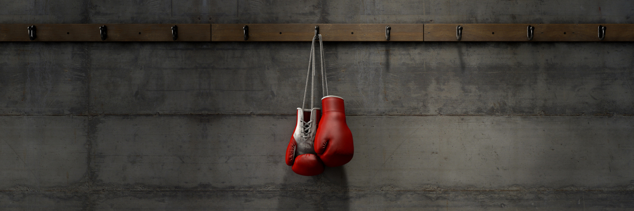 When Multiple Sclerosis Punches You in the Gut A pair of hanging boxing gloves.