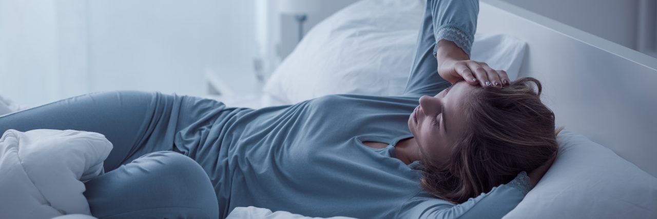 Top Strategies for Dealing With a CRPS/RSD Flare woman lying in bed exhausted