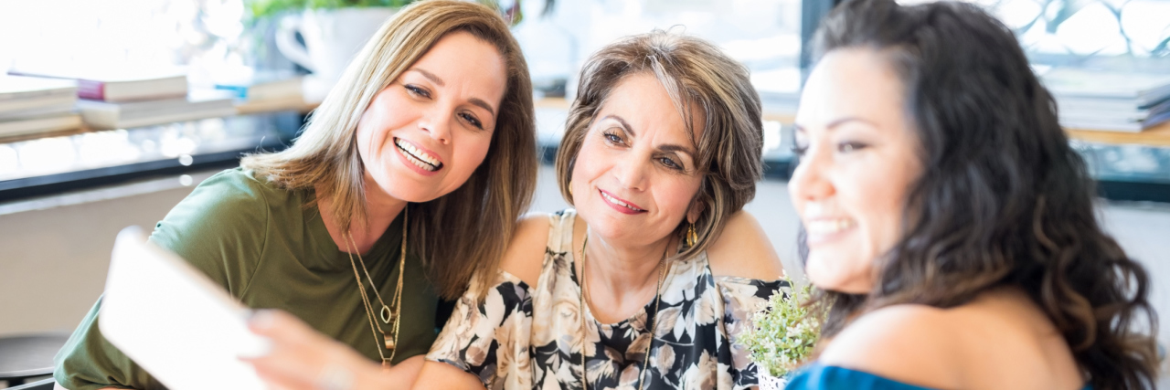 When You Feel Ready to Reconnect With Friends After Years of Illness Women taking a selfie at a coffee shop.