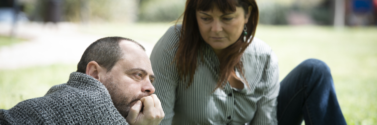 Panic Attacks At Work With Autism Woman supporting stressed out man.