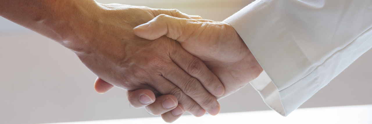 How a Doctor and I Had Both Had to Overcome Our Prejudices A photo of a male doctor's hand shaking another man's hand.
