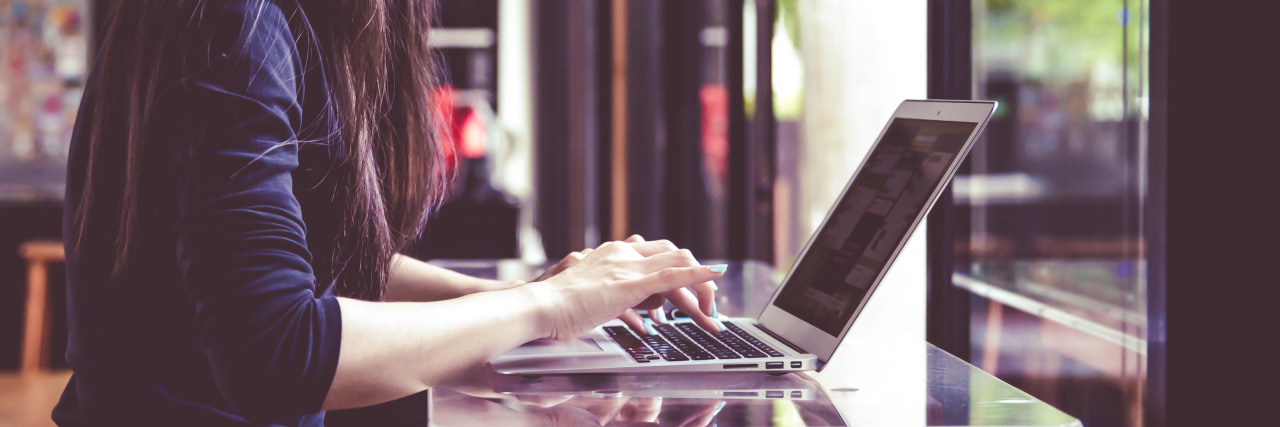 The Job Roles That Helped Improve My Mental Health young woman working at coffee shop with laptop