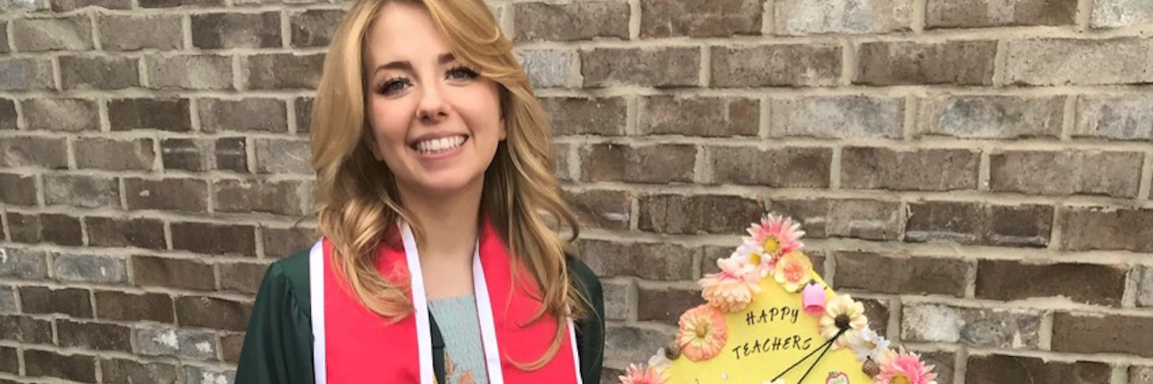 If You Thought I Couldn't Become a Teacher Because of My Disability The writer in her graduation gown, holding her graduation cap.