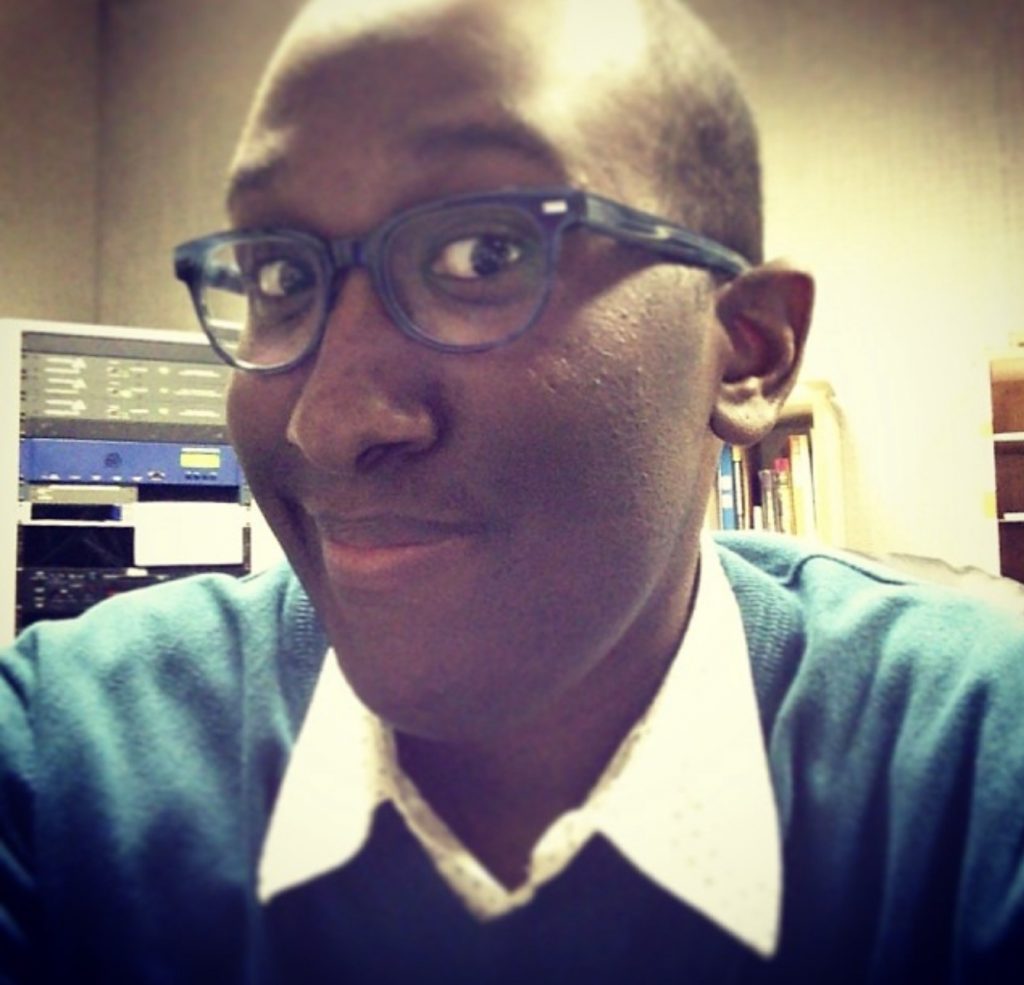 man wearing a collared shirt and glasses taking a selfie to show freckles on his face