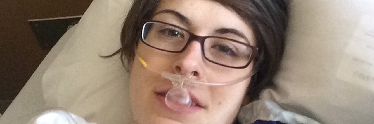 A photo of the writer in a hospital bed, wearing oxygen.