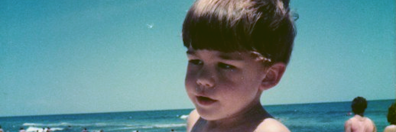 A picture of the writer on the beach as a child.