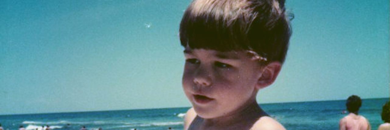 Was It Better for My Health for Me to Think I Was 'Fixed?' A picture of the writer on the beach as a child.