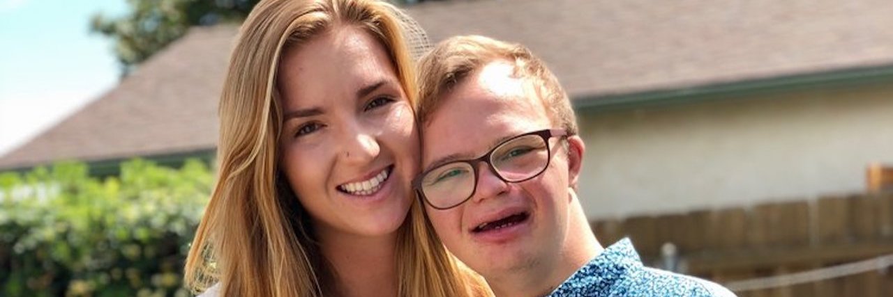 How to Approach My Brother With Down Syndrome Image of Julia with twin brother Michael who has Down syndrome.They are huggig and holding hands smiling at camera.
