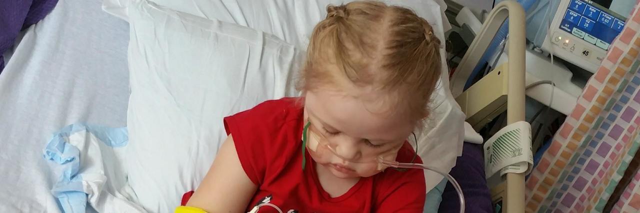 Our Response When People Ask If Our Daughter Is Playing Doctor little girl playing with medical supplies