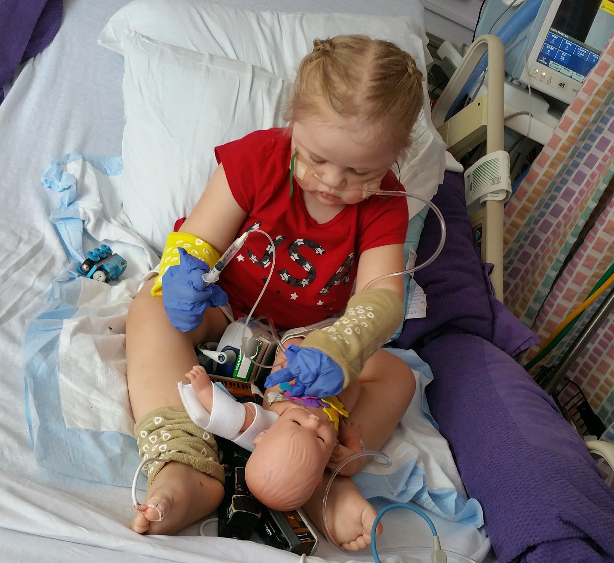 little girl playing with medical supplies