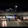 Semi-trucks under a bridge
