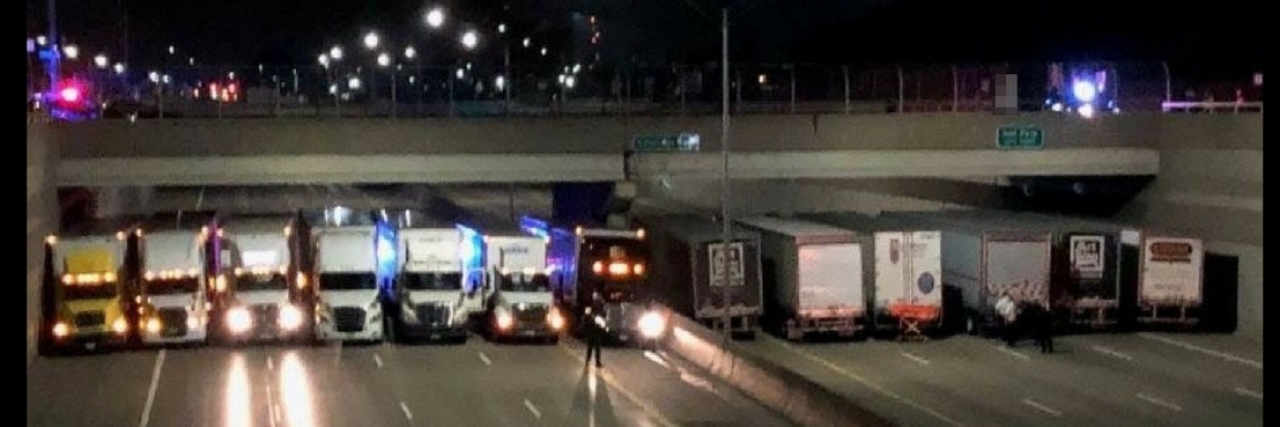 Michigan State Police Use Trucks on Highway to Save Suicidal Man Semi-trucks under a bridge