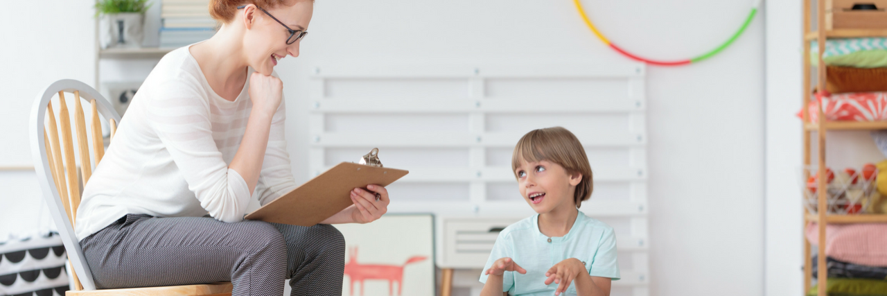 CDC Report Shows Higher Rate of Autism in Children A boy talking to a woman