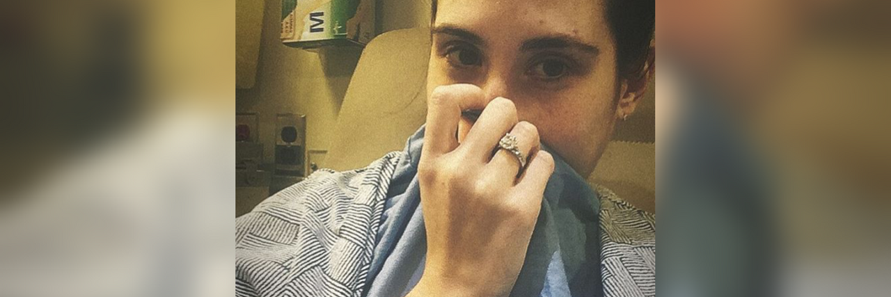 Getting a Virus on Top of Chronic Illness woman taking in a selfie in the hospital with the hashtag #crohnslife