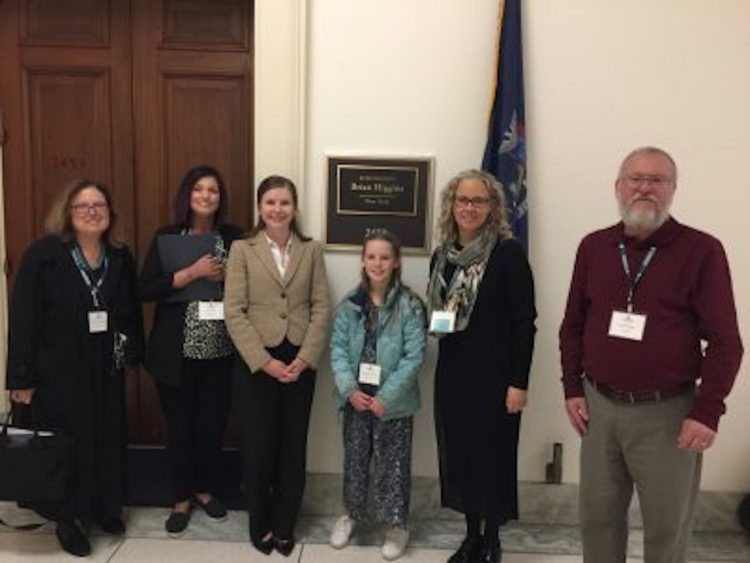 Aimee and other advocates standing in front of a representatives office