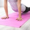 woman doing yoga on a pink mat