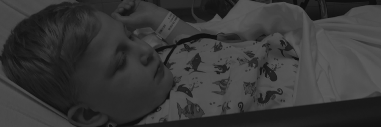 What It Feels Like When Your Child Spends Days at the Hospital the author's son in a hospital bed. photo says 'you are braver than you will ever know."
