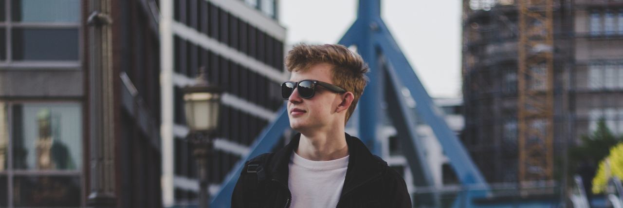 Another 5 Things That Make Me Brave as a Man With Autism man walking down the street with sunglasses on