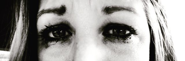 Black and white close up of woman's eyes with tears