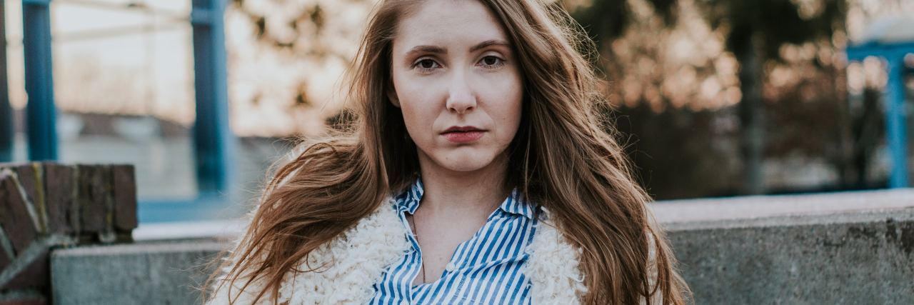 4 'Well-Meaning' Quotes in Response to Suicidal Thoughts woman with blonde hair sitting on steps looking somber into camera