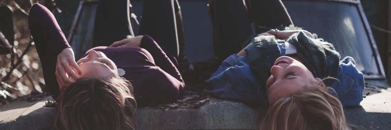 Positives to Living Life With Bipolar Disorder friends lying on hood of car and talking