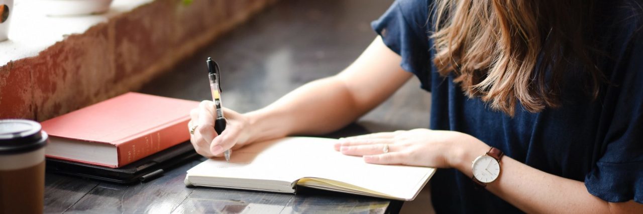 How Creative Journaling Helps my Anxiety young woman journaling beside window