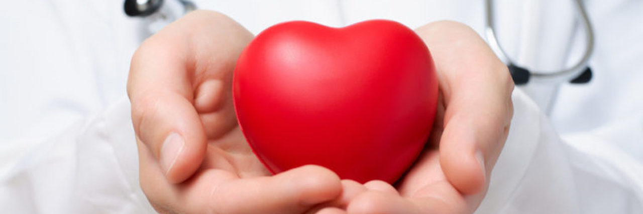 A Doctor's Perspective on Organ Donation and Heart Transplant doctor holding a plastic heart in his hands