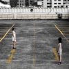two women standing on car park roof with opposite lines and arrows