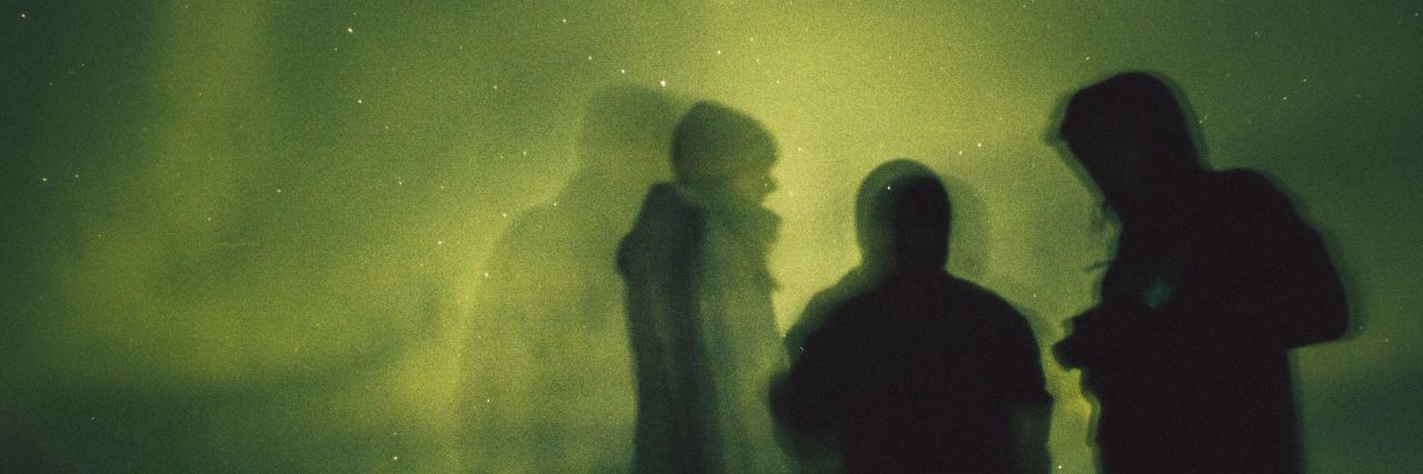 The Best and Worst Remarks About Our Dissociative Identity Disorder three people framed against green aurora borealis northern lights