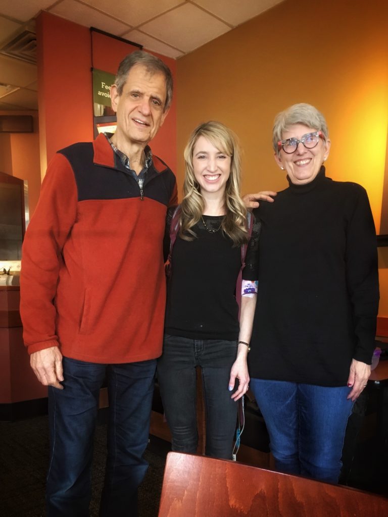 the author smiling and standing with two other people