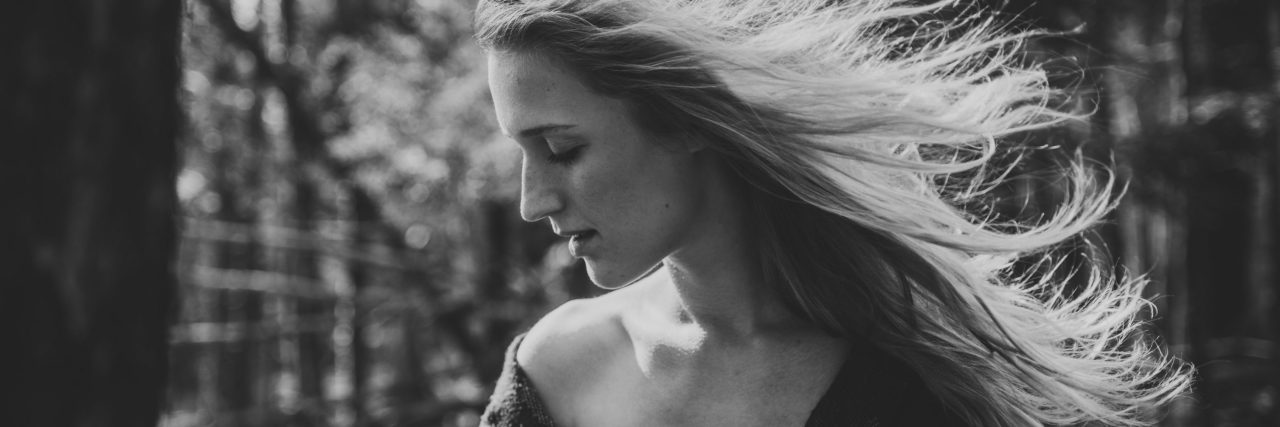 black and white photo of blonde woman looking regretful