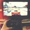 view of playstation controller in front of TV